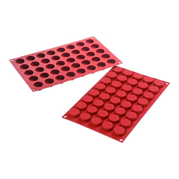 A couple of red Silikomart round silicone baking molds with 40 half inch cavities.