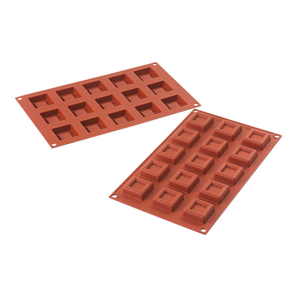 Two red Silikomart square silicone baking molds.