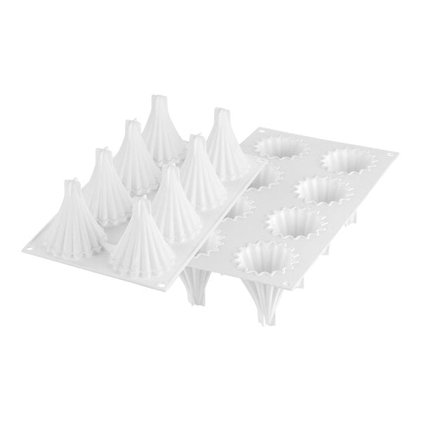 A white Silikomart silicone baking mold with 8 pointy cone-shaped cavities.