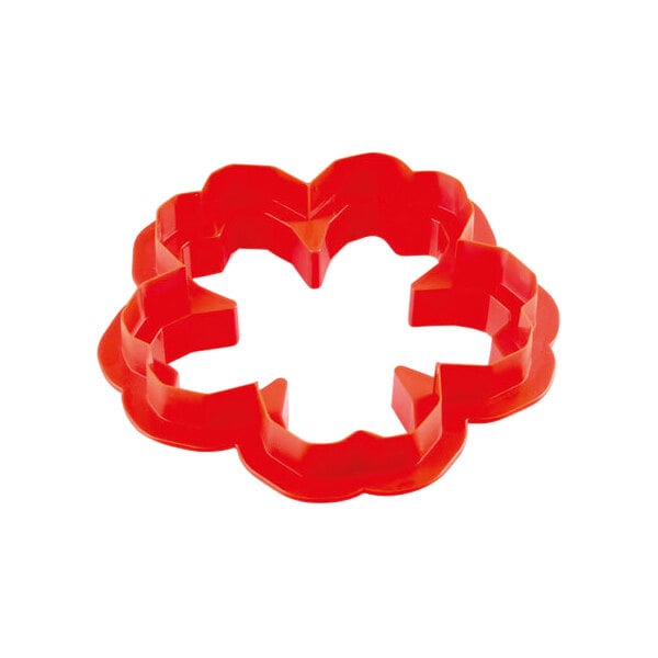 A red cookie cutter with four leaves.