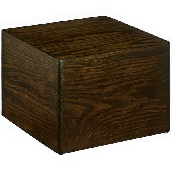 A square oak display riser on a table.