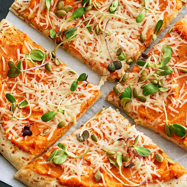 A square pizza with Violife vegan mozzarella cheese and sprouts on a white background.