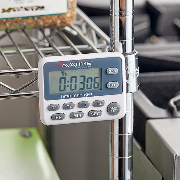 An AvaTime digital kitchen timer on a shelf with a clock.