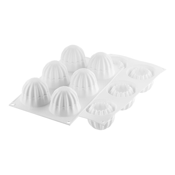 A white plastic tray with six Silikomart Curve Supernova silicone molds.