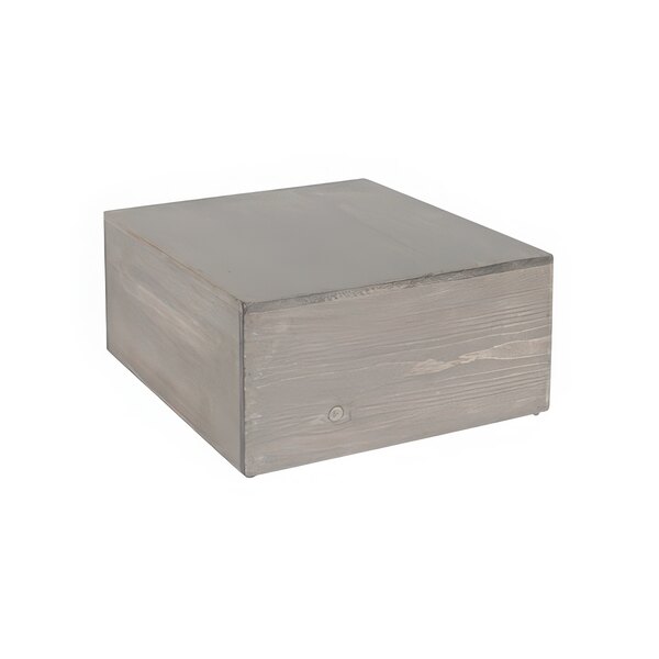 A gray wooden display riser with a lid on top.