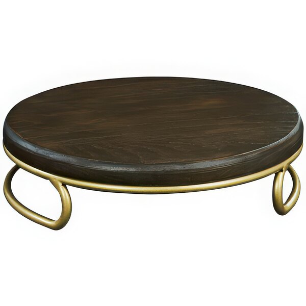 A round wooden table with a gold rim and a Cal-Mil Heritage gold and dark oak display riser on top.