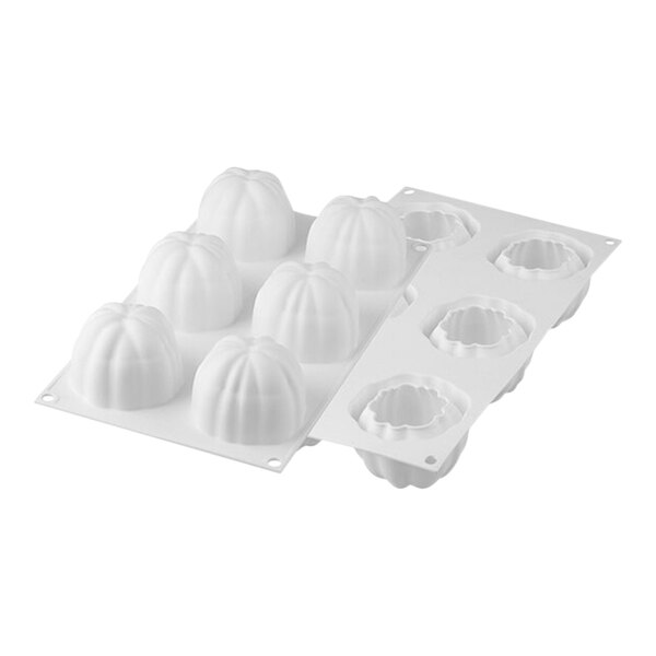 A white Silikomart silicone baking mold with 6 curved bloom-shaped cavities.