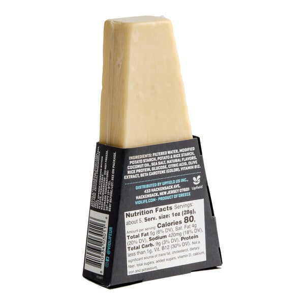 A wedge of Violife Just Like Parmesan vegan cheese in a black and white package.