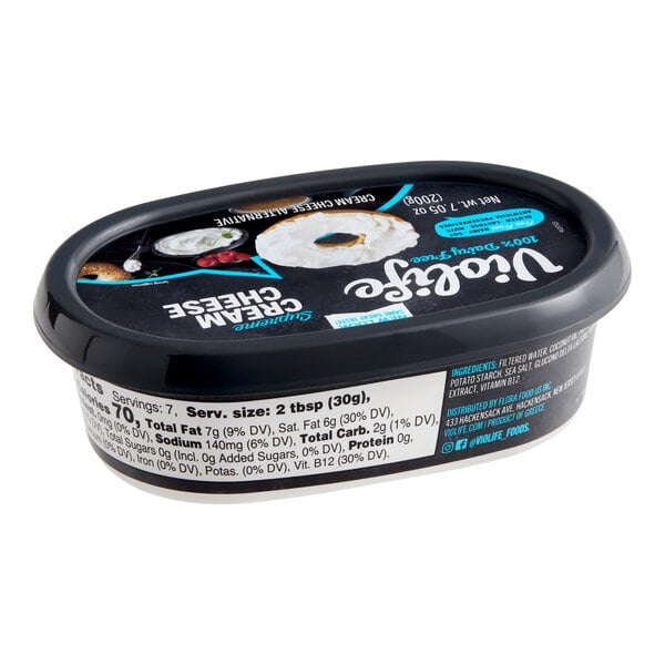 A black plastic tub of Violife Just Like Original Cream Cheese vegan spread.