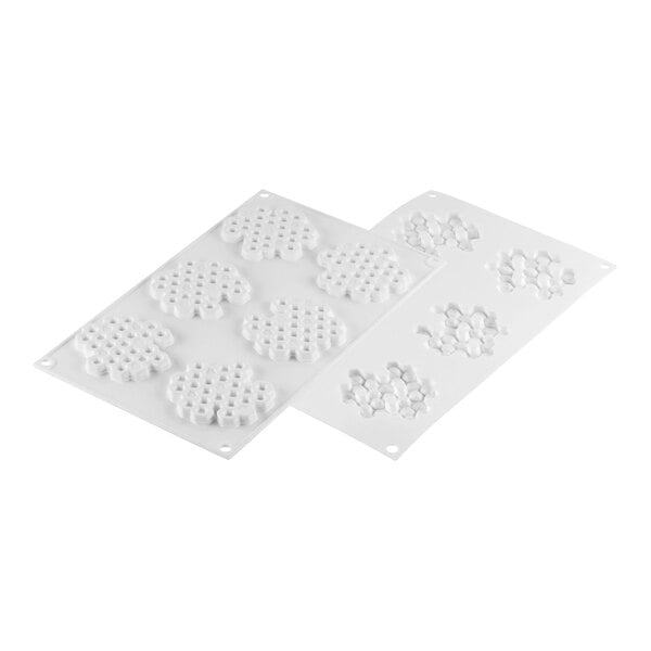 A white Silikomart silicone baking mold with honeycomb-shaped cavities.
