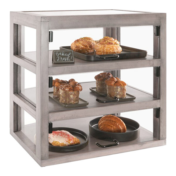 A Cal-Mil bakery display case with pastries on it.