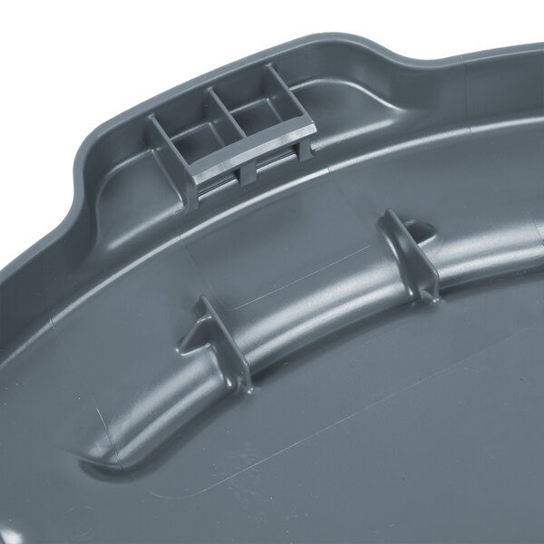 A Rubbermaid gray plastic lid for a 55 gallon trash can.