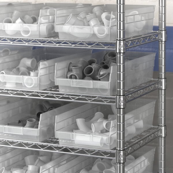 Clear plastic Regency shelf bins on a metal shelving unit.