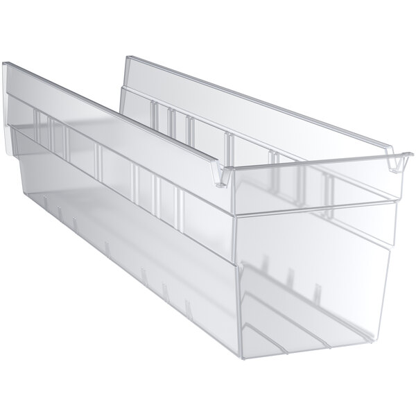 A clear plastic Regency shelf bin with two compartments.