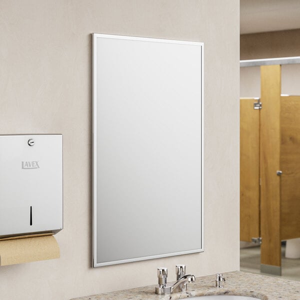 American Specialties, Inc. Plate Glass Mirror with a Stainless Steel Chan-Lok Frame above a sink in a bathroom.