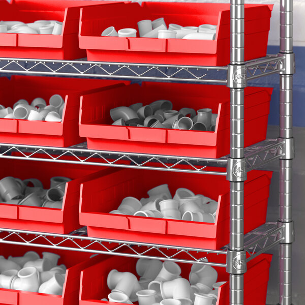 A red Regency shelf bin on a shelf with white objects.