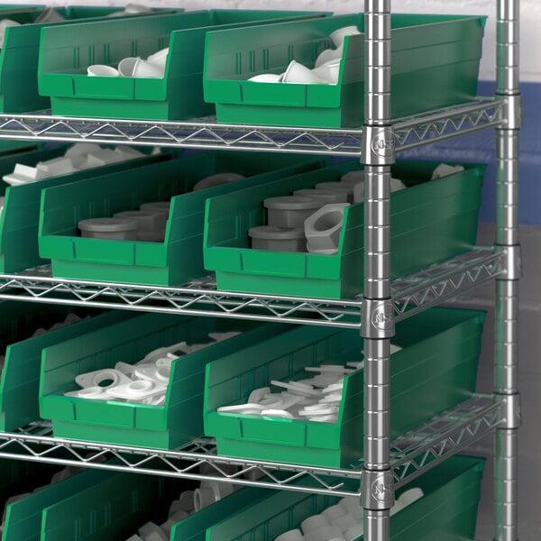 A metal shelf with a Regency green bin holding white plastic rings.