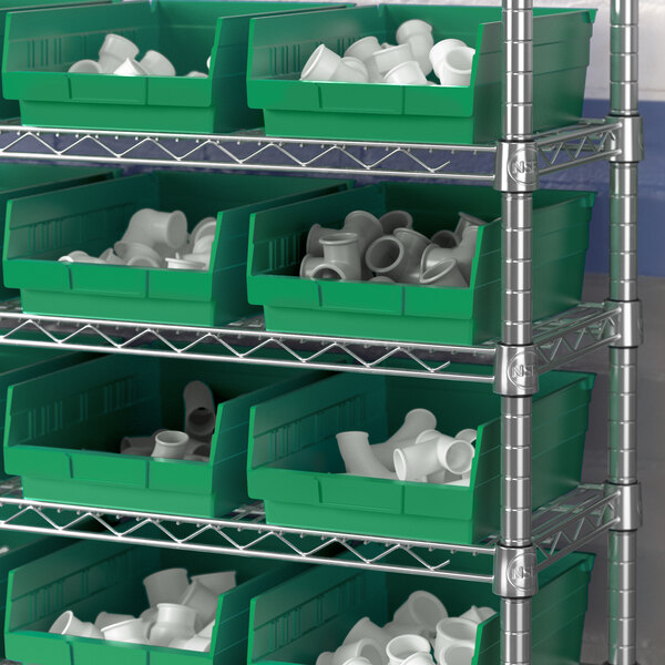 A shelf with green Regency shelf bins.