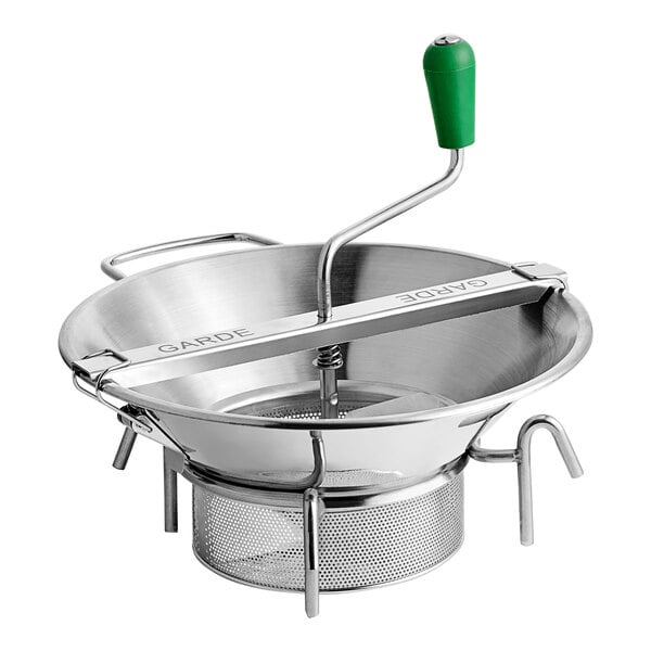 A Garde stainless steel rotary food mill with a green handle on a metal bowl.