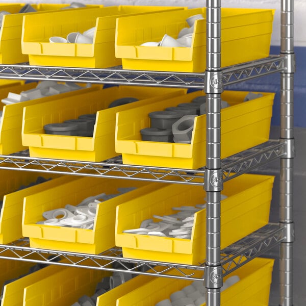 A metal shelf with yellow Regency plastic bins filled with white and grey objects.