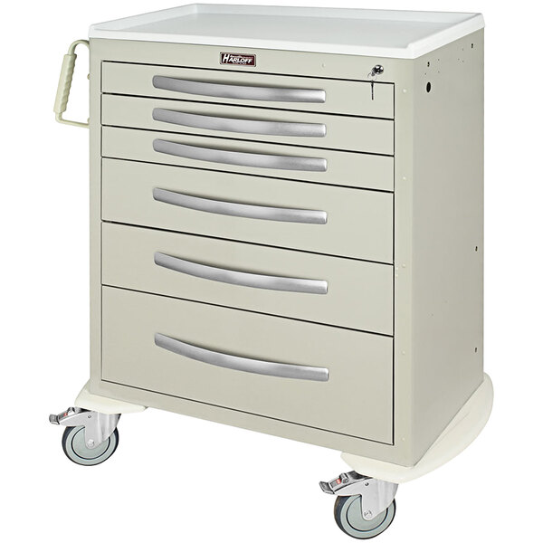 A white medical cart with silver handles and drawers.