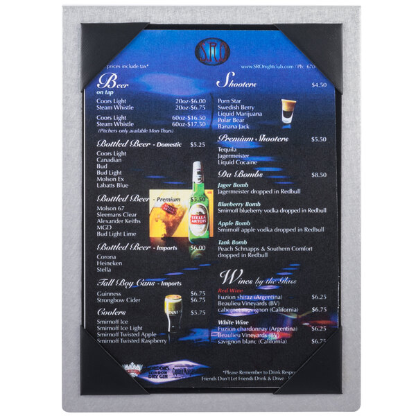 A brushed aluminum Menu Solutions table tent on an Asian cuisine restaurant table with a menu inside.