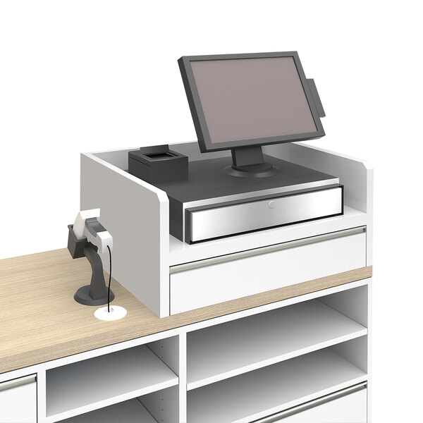 A white Econoco register well on a retail counter with a computer monitor on top.