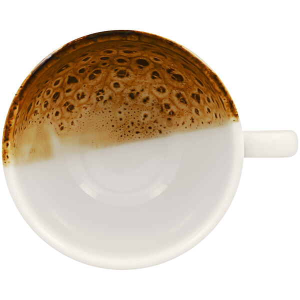 A white porcelain coffee cup with a brown and white design.