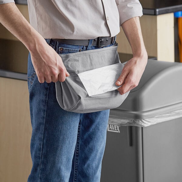 A person holding a Lavex gray waist trash bag