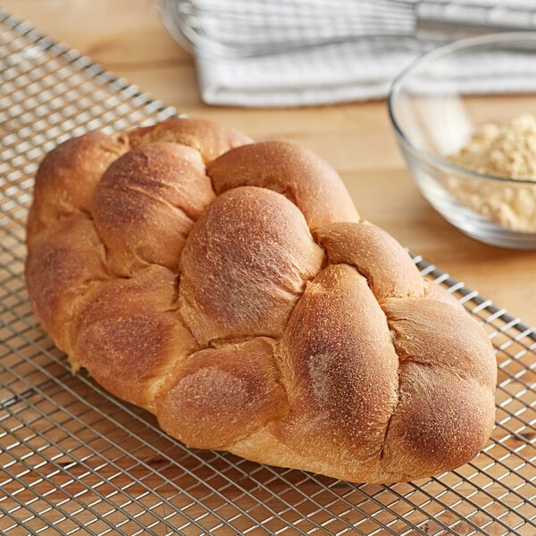 A loaf of bread on a cooling rack.