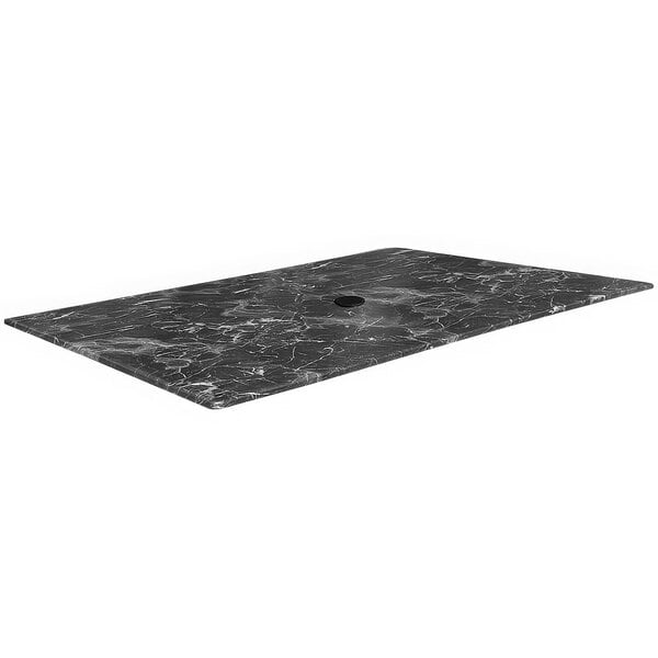 A rectangular black marble table top with an umbrella hole.