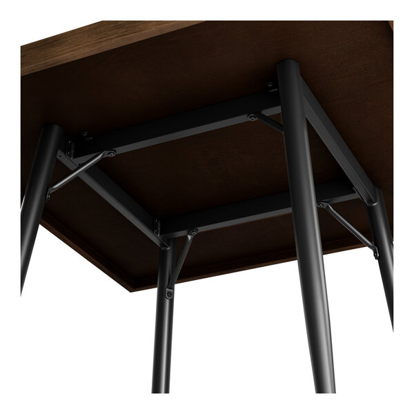 A Lancaster Table & Seating butcher block table with metal legs.