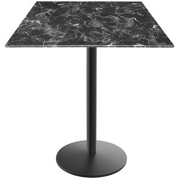 A Holland Bar Stool black marble table with round metal base.