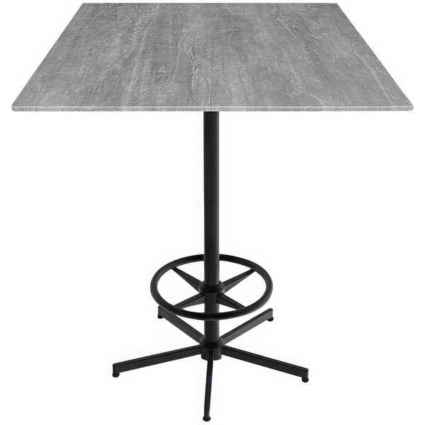 A Holland Bar Stool EuroSlim bar height table with a metal base and a grey square top.