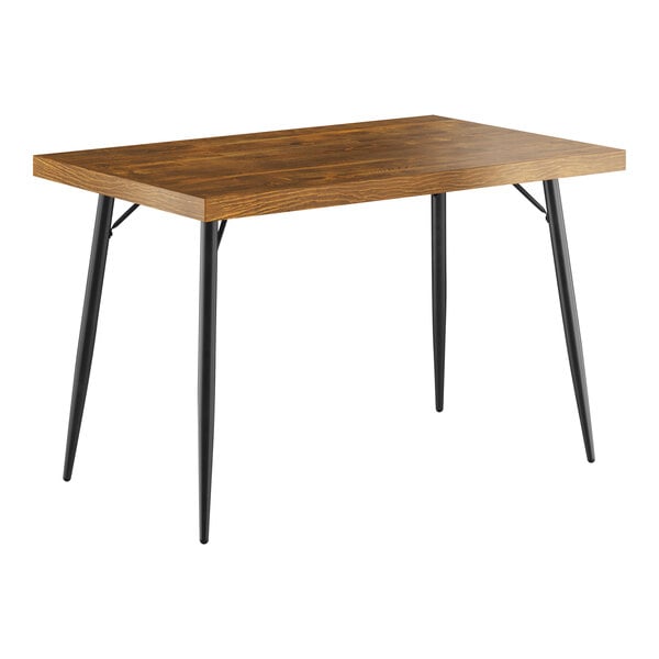 A Lancaster Table & Seating butcher block table with black legs.