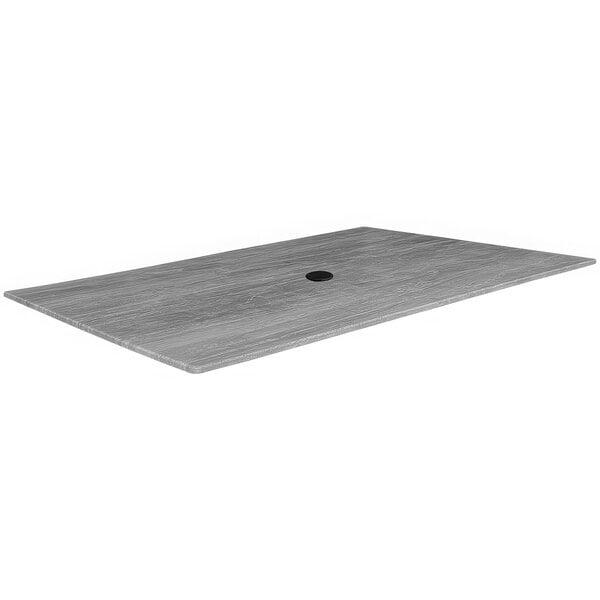 A rectangular grey table top with a black umbrella hole.