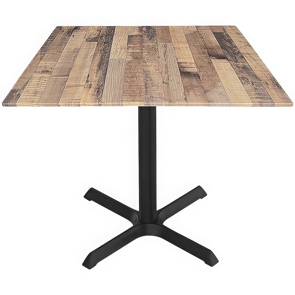 A Holland Bar Stool EuroSlim square table with a rustic wood top and black metal cross base.