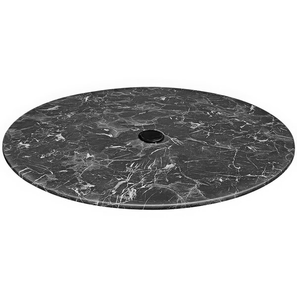 A round black marble table top with an umbrella hole.