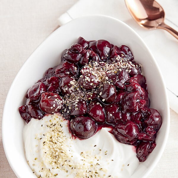 A bowl of yogurt with IQF organic pitted dark sweet cherries.