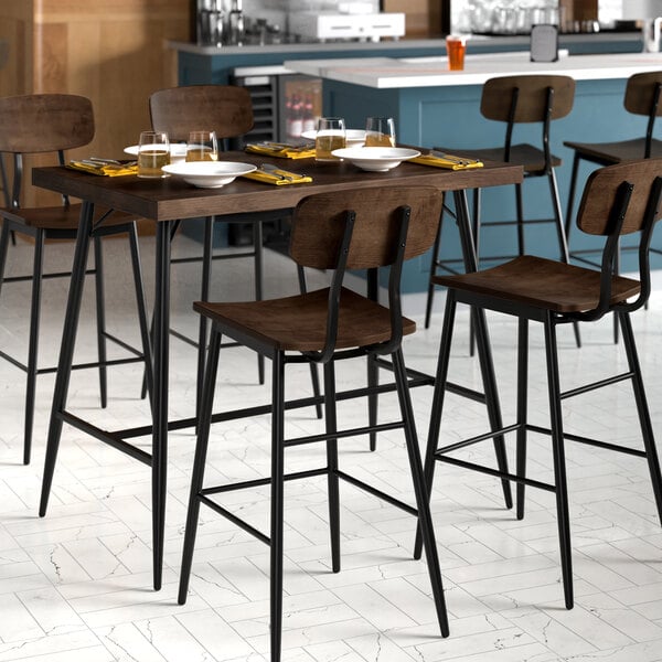 A Lancaster Table & Seating Mid-Century rectangular bar height table with an espresso finish and 4 barstools.