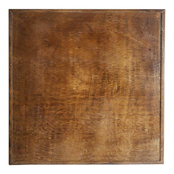 A Lancaster Table & Seating Mid-Century wooden square table with a vintage finish.