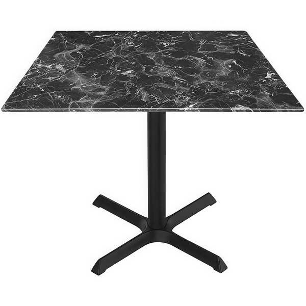 A black marble table top with a black cross base.