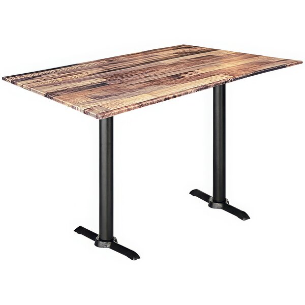 A Holland Bar Stool rustic wood table with a black metal base.