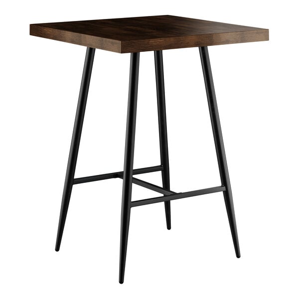 A Lancaster Table & Seating butcher block bar table with black metal legs.