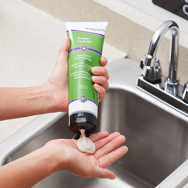 A hand pouring SC Johnson Professional Kresto Classic heavy-duty soap into another hand.