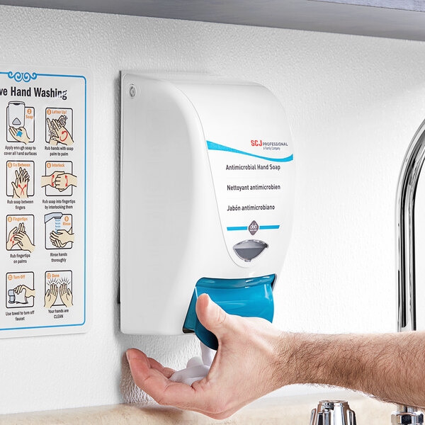 A white and blue SC Johnson Professional foaming hand soap dispenser on a counter.