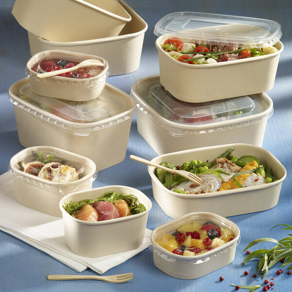 A group of Solia rectangular bamboo fiber containers with food in them.