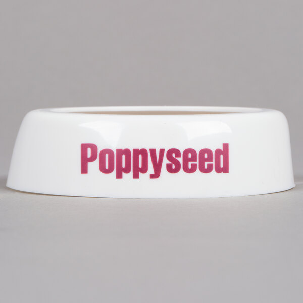 A white Tablecraft plastic salad dressing dispenser collar with maroon text reading "poppyseed"
