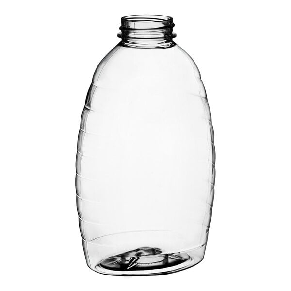 A clear plastic Classic Queenline honey bottle with a black lid.