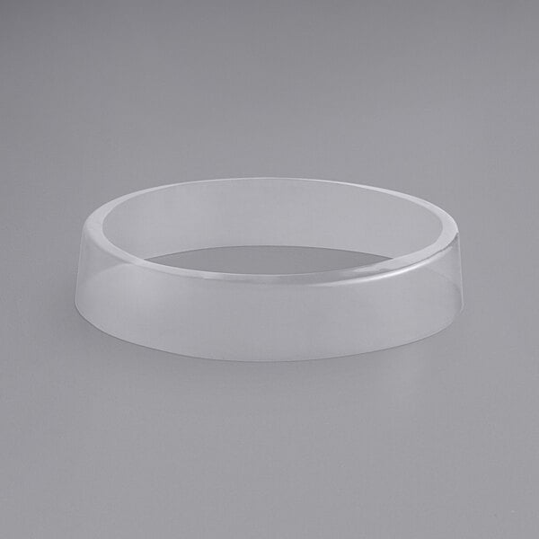 A clear plastic ring on a white surface.